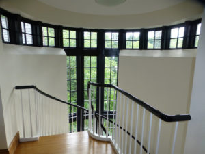 A spiral staircase with black banister